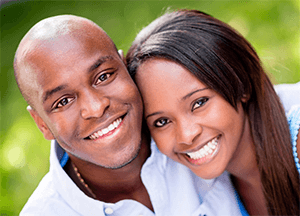 A man and a woman are smiling for the camera.