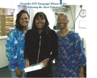 Three women are posing for a picture with the caption november 2011 campaign winner referring the most patients