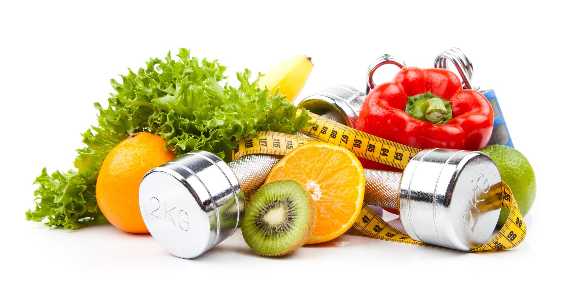 A bunch of fruits and vegetables with dumbbells and a measuring tape.