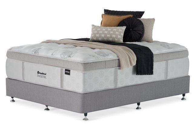 View of a double bed with mattress and pillow