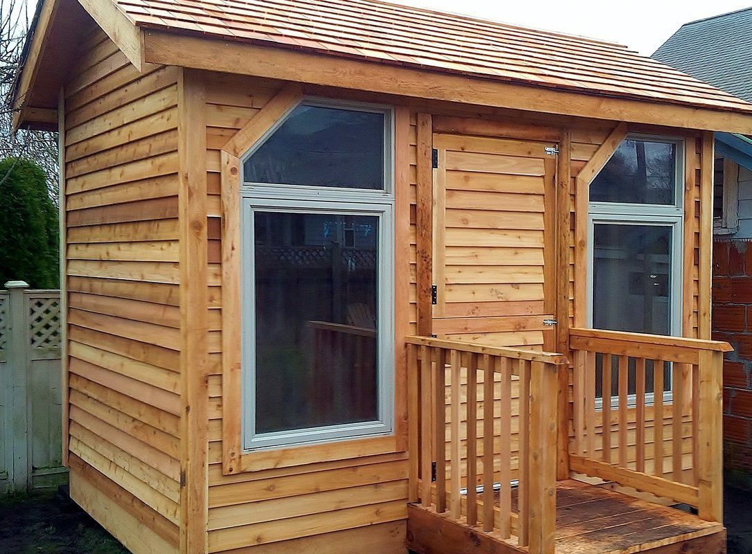 A wooden shed with slim door and wide glass windows built for landscaping project in Victoria BC