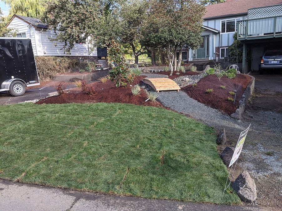 green lawn with garden path and artificial stream