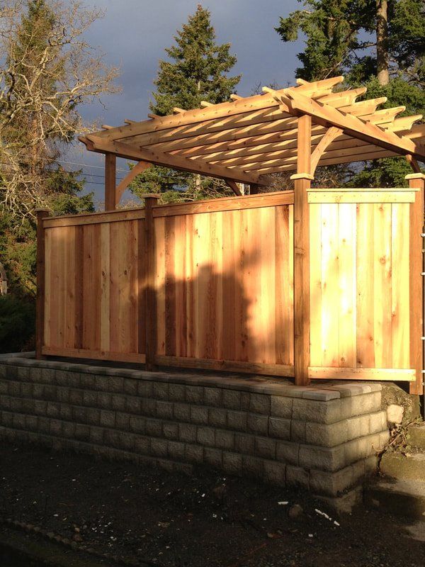 Custom fence and pergola trellis construction for patio timber-frame garden feature