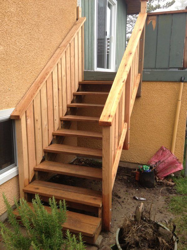 Custom stairs leading up to back door of residential home