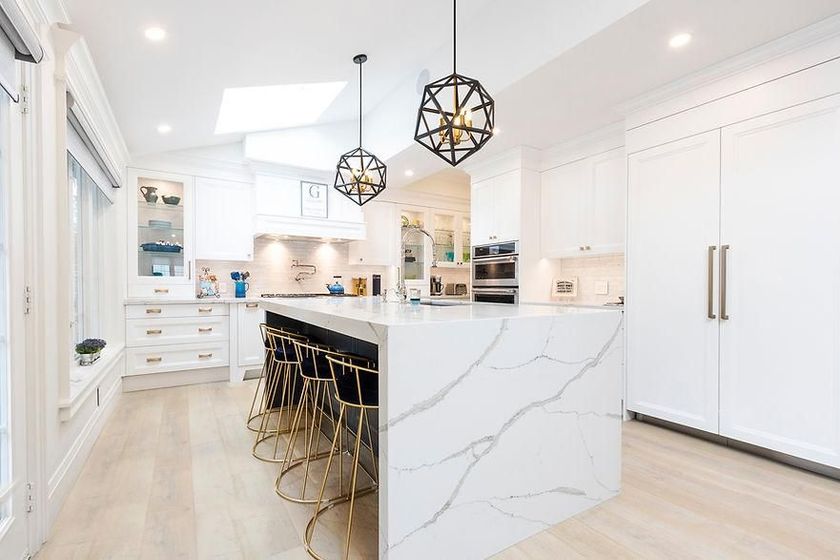 There is a large island in the middle of the kitchen.