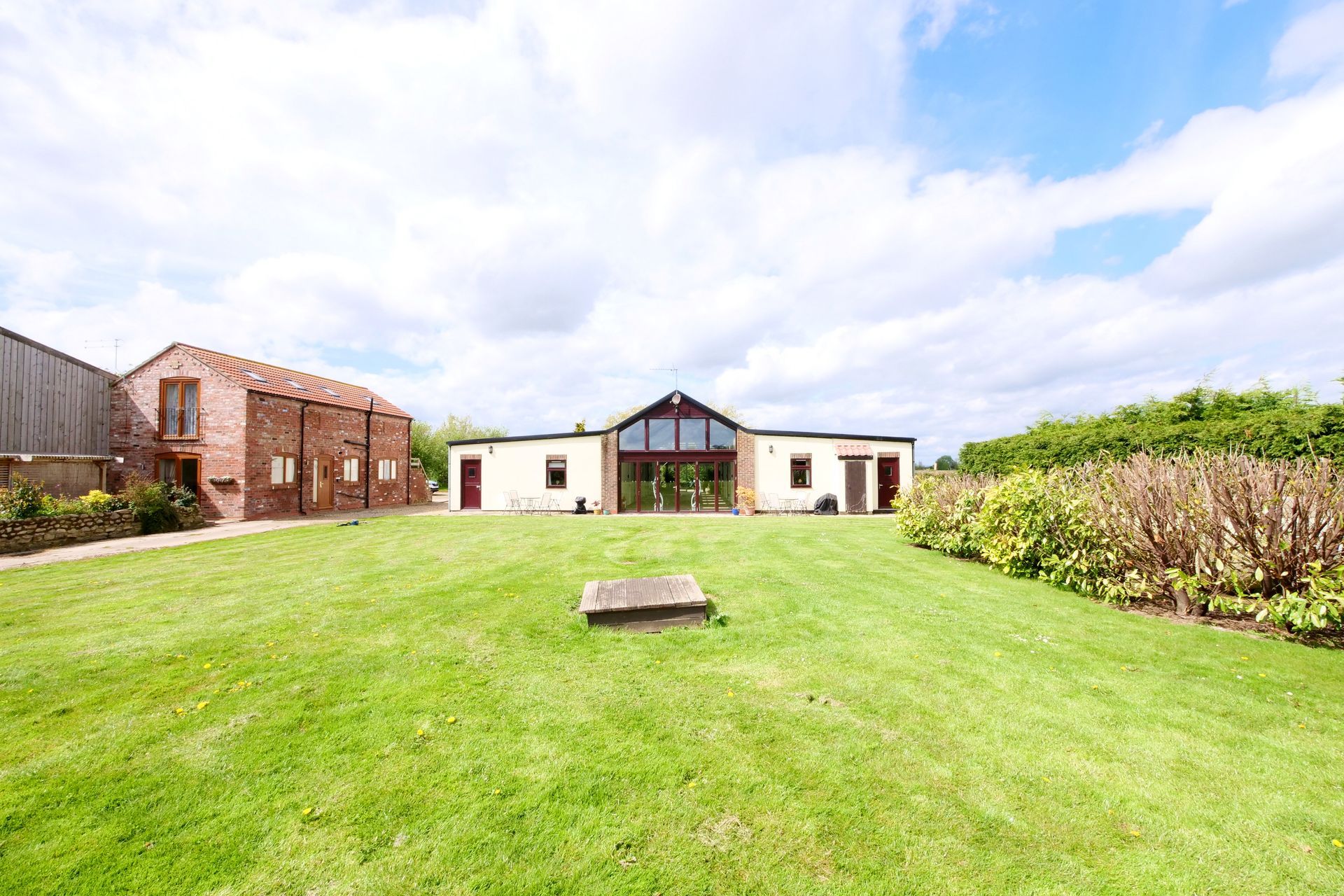 A large house with a large lawn in front of it.