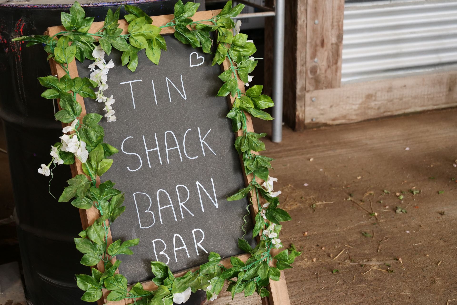 A chalkboard sign for the tin shack barn bar