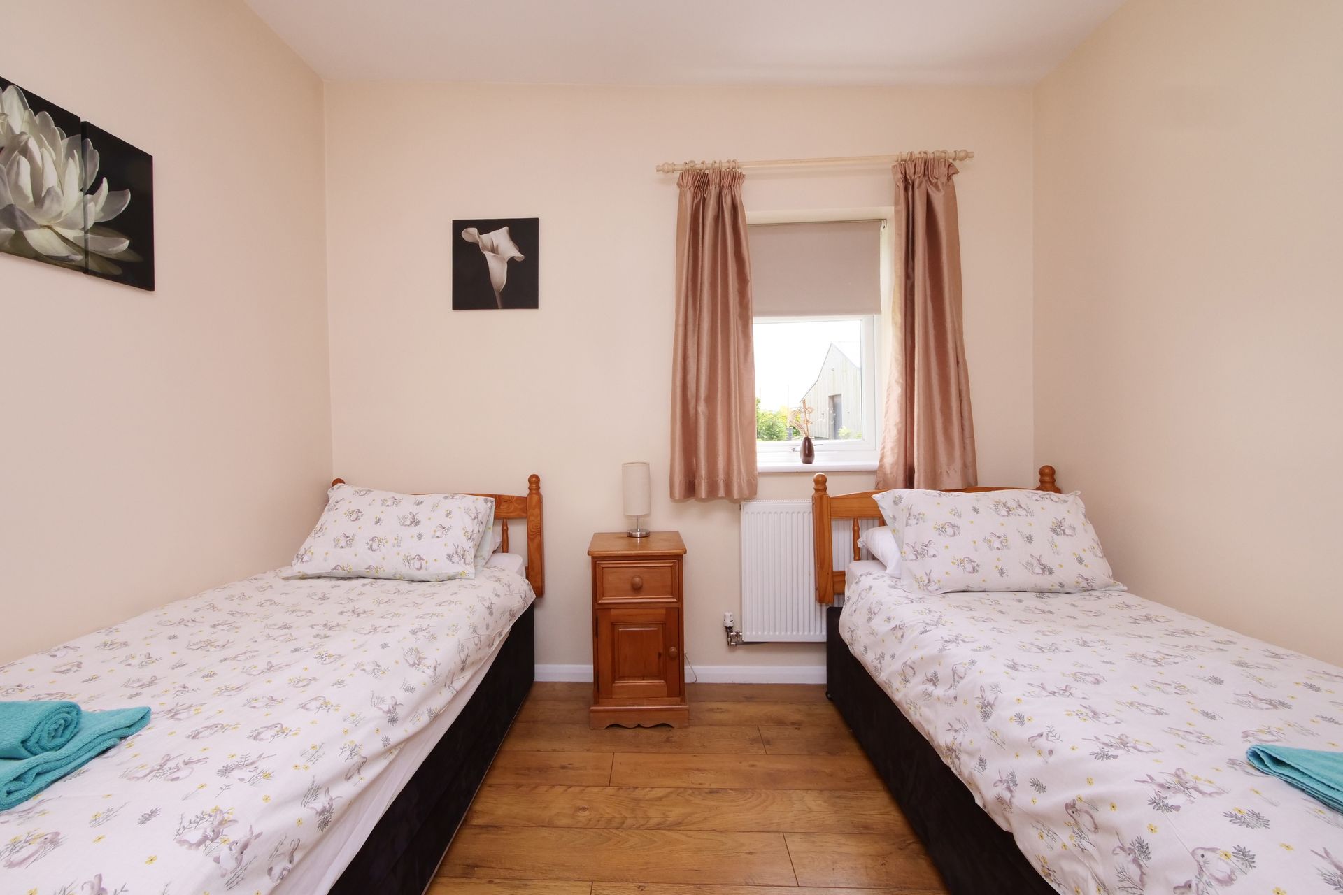 A bedroom with two twin beds and a nightstand