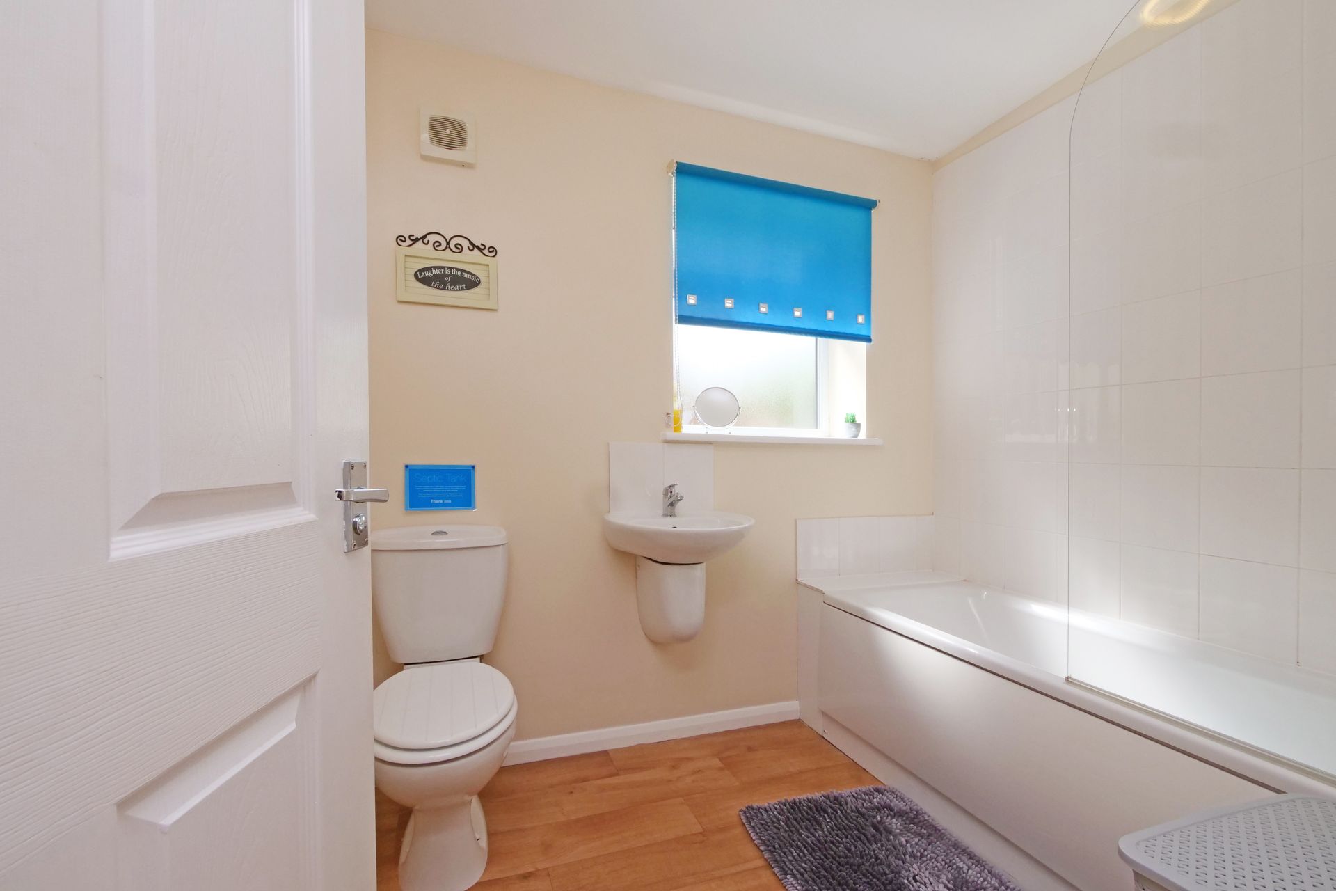 A bathroom with a toilet , sink and bathtub