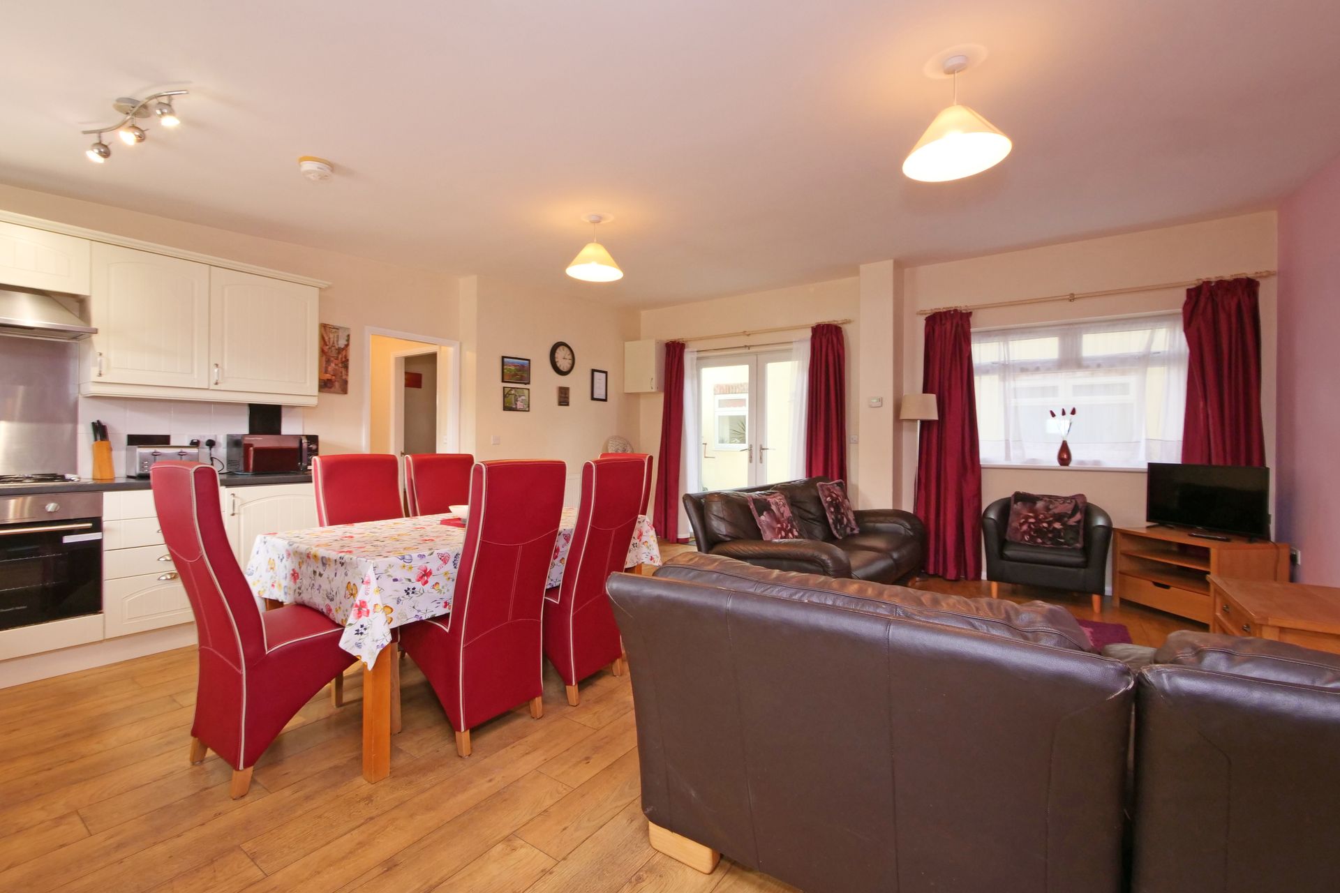 A living room with a dining table and chairs and a couch.