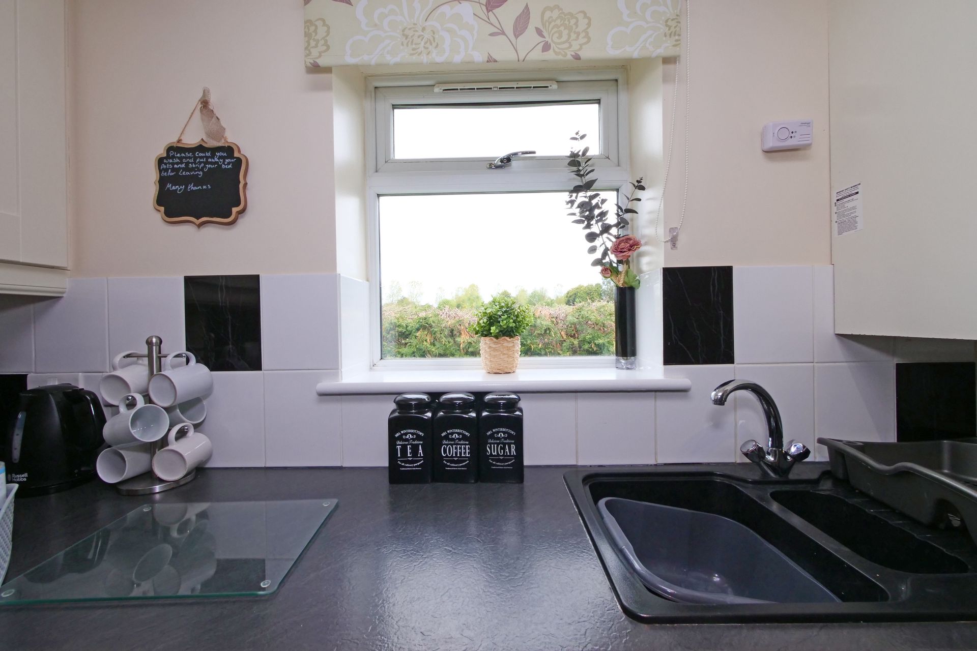 A kitchen counter with a sink and a window