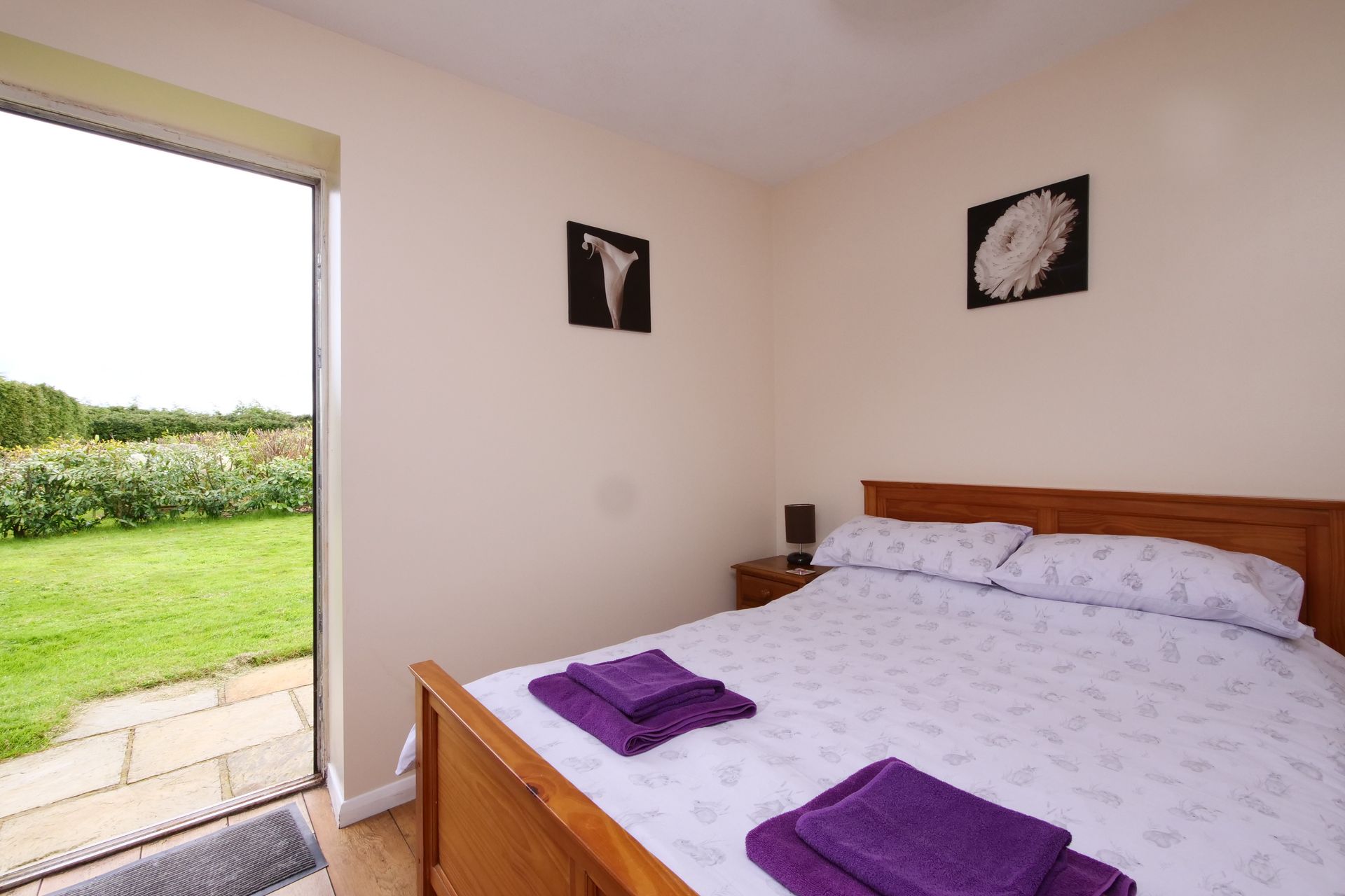A bedroom with a large bed and a sliding glass door