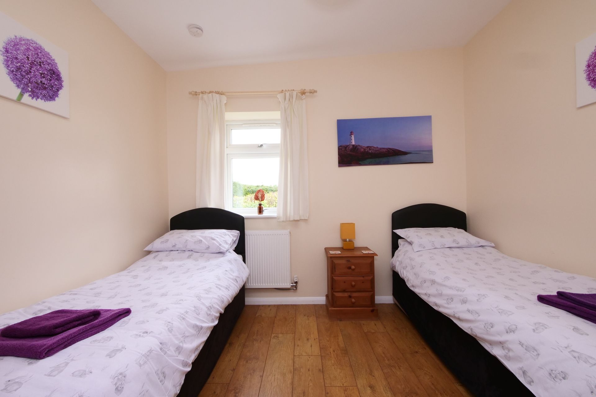 A bedroom with two twin beds and a nightstand