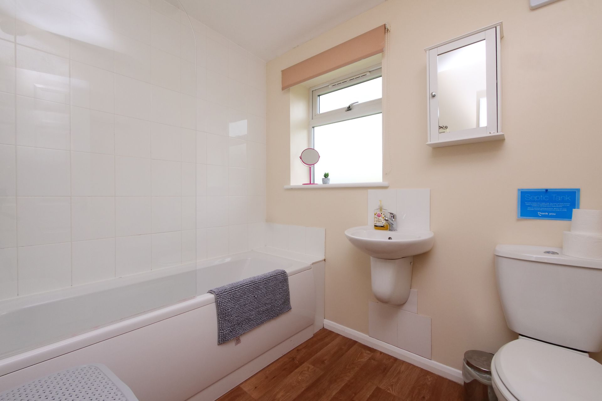 A bathroom with a sink , toilet and bathtub.