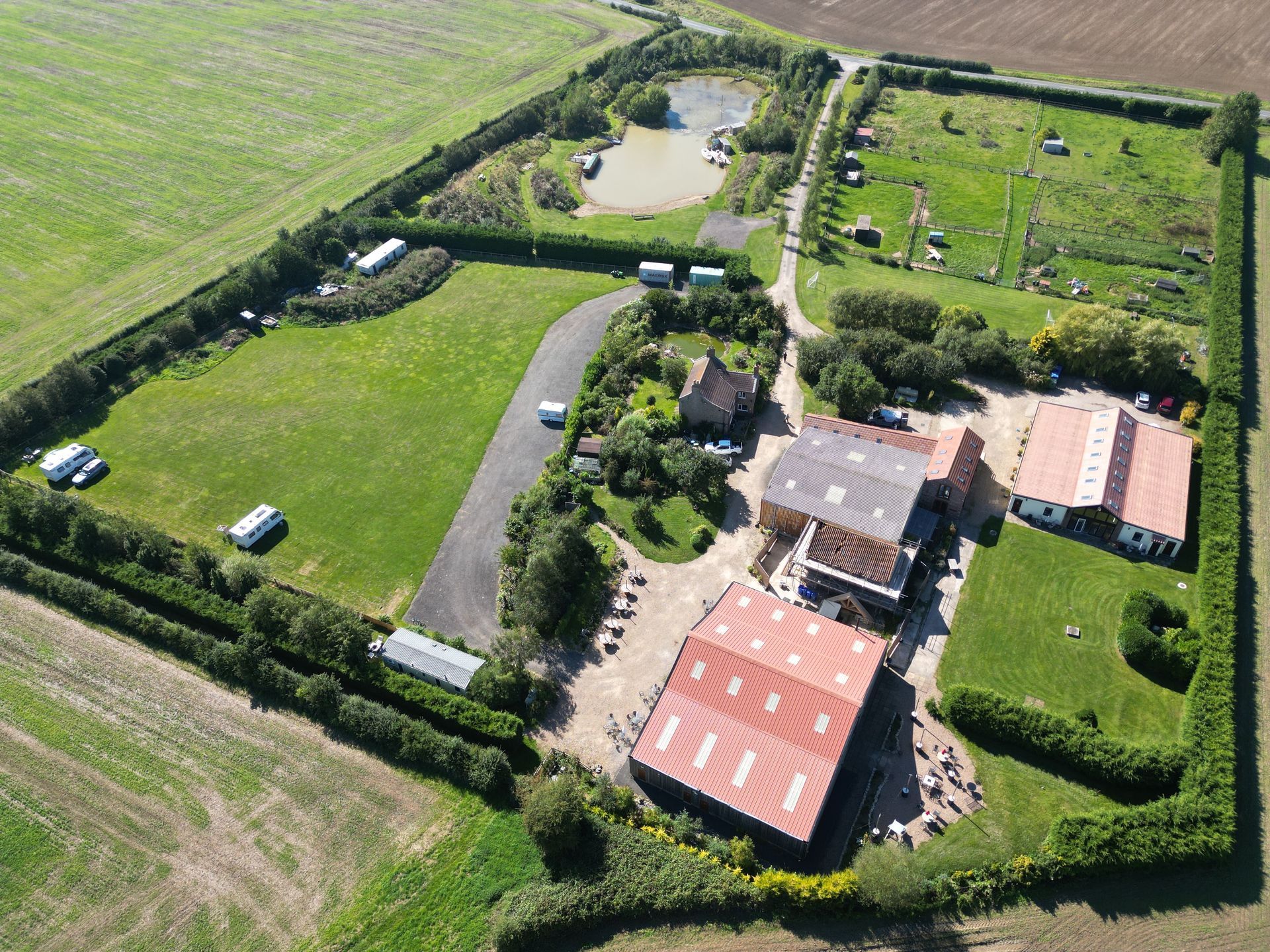 An aerial view of Clapham Holme Farm with a red roof