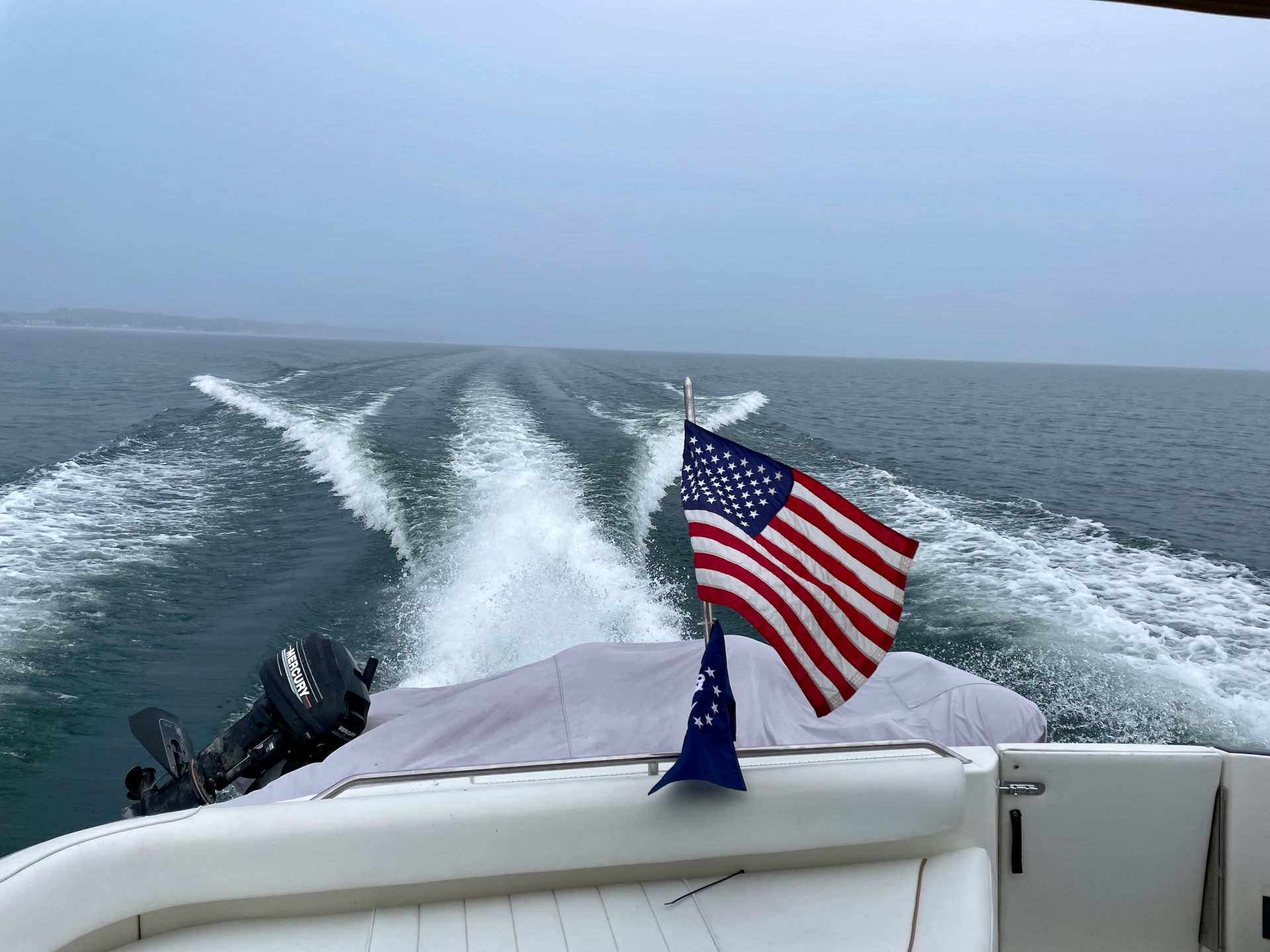 A group of people are riding a speed boat on a lake.
