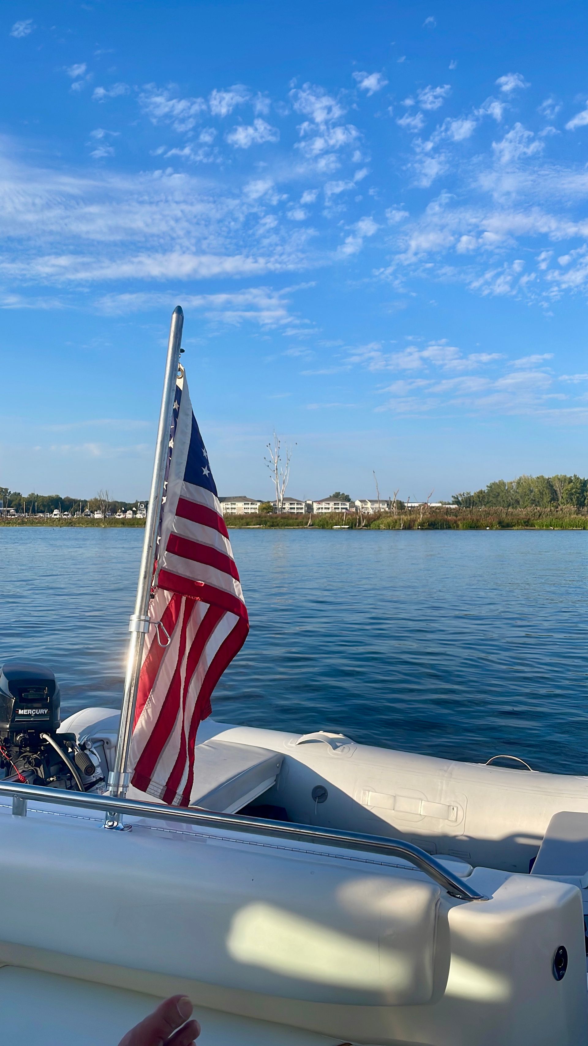A man and a woman are walking on a dock next to a boat.