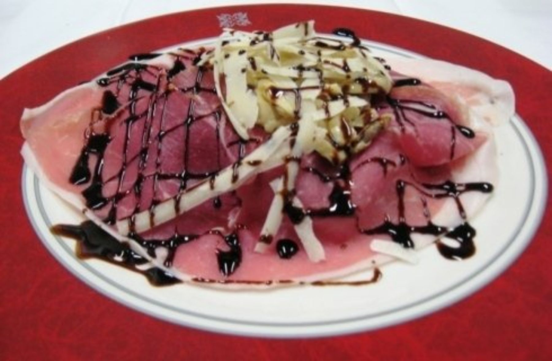 prosciutto crudo con grana e glassa di aceto balsamico