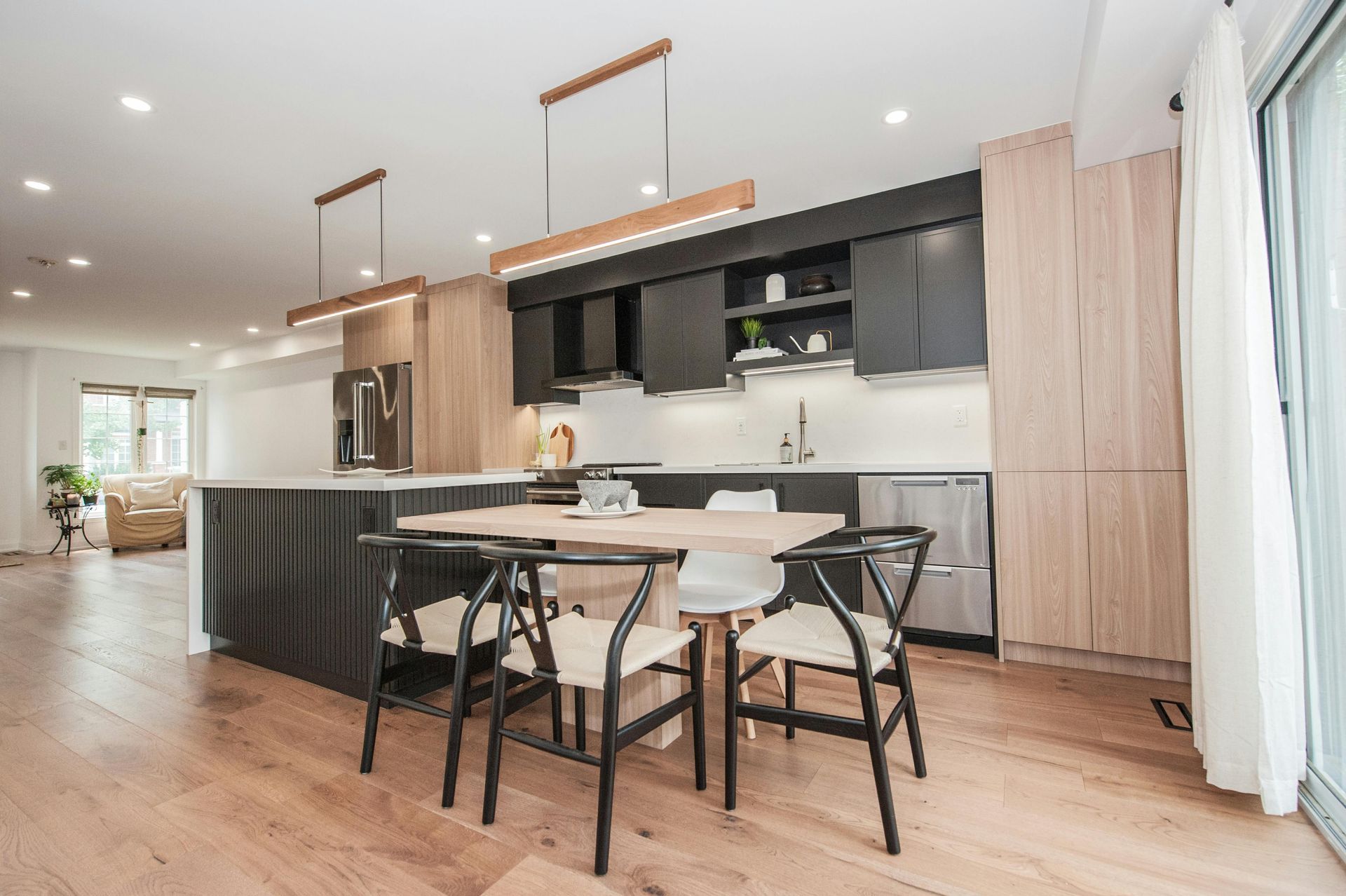 A kitchen with a dining table and chairs in it.