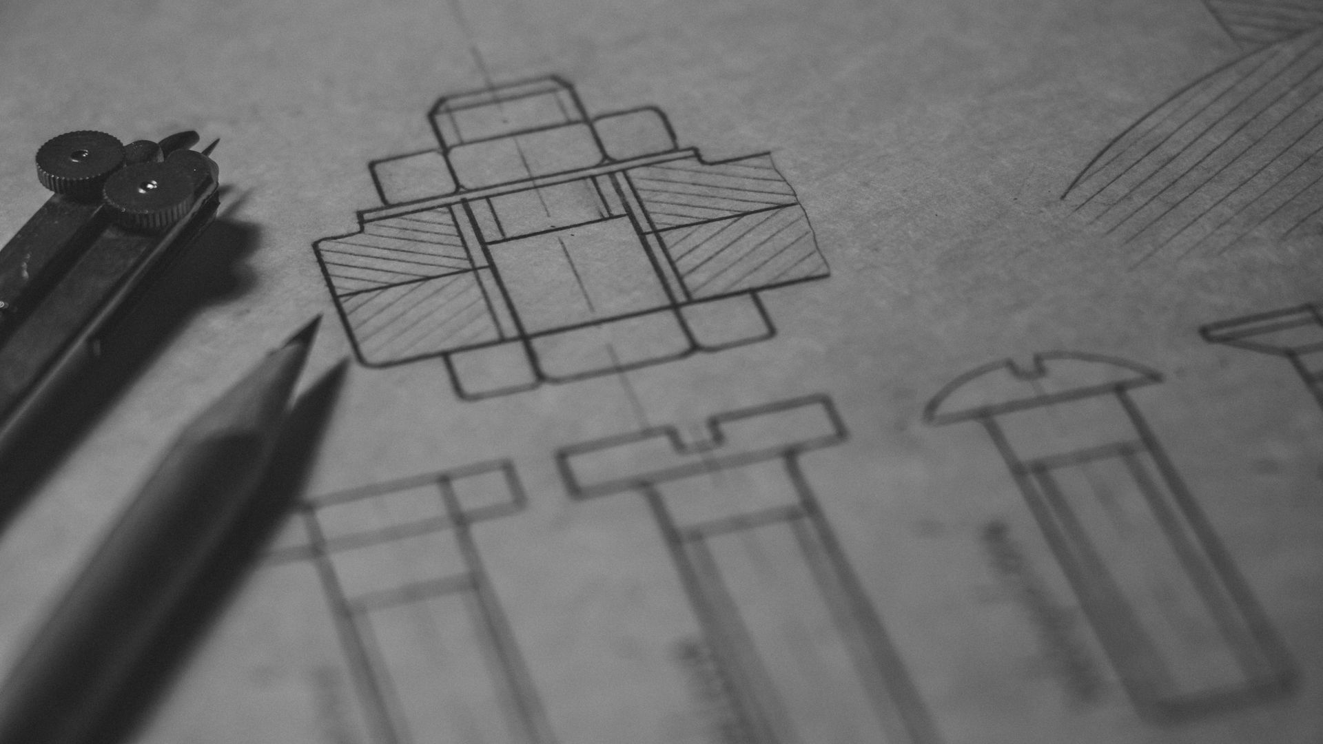 A black and white photo of a drawing of a box with a compass and pencils.