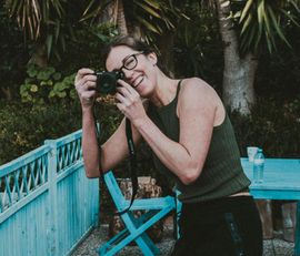 A woman is taking a picture with a nikon camera