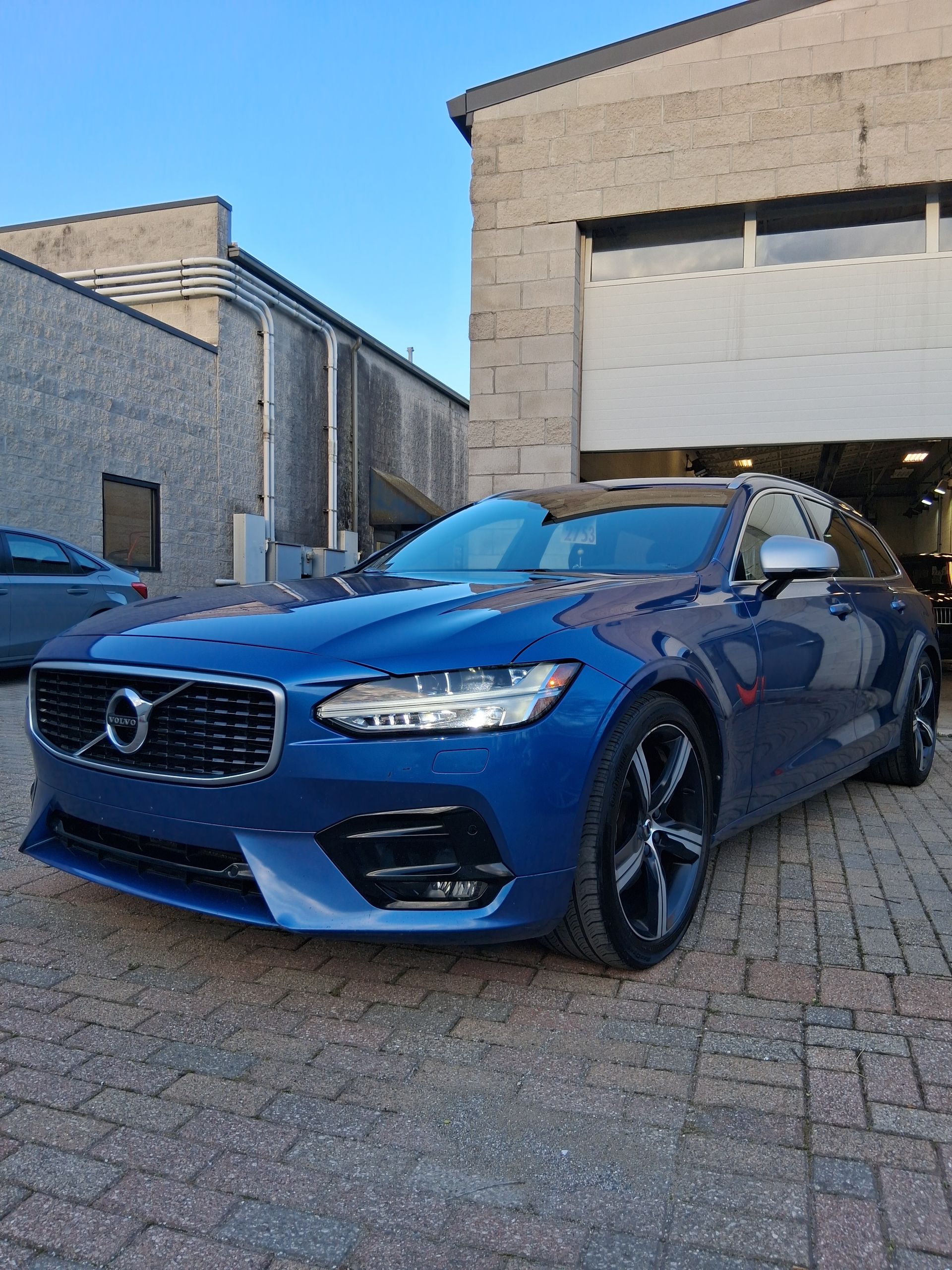 The trunk of a corvette with a red rug and boxes
