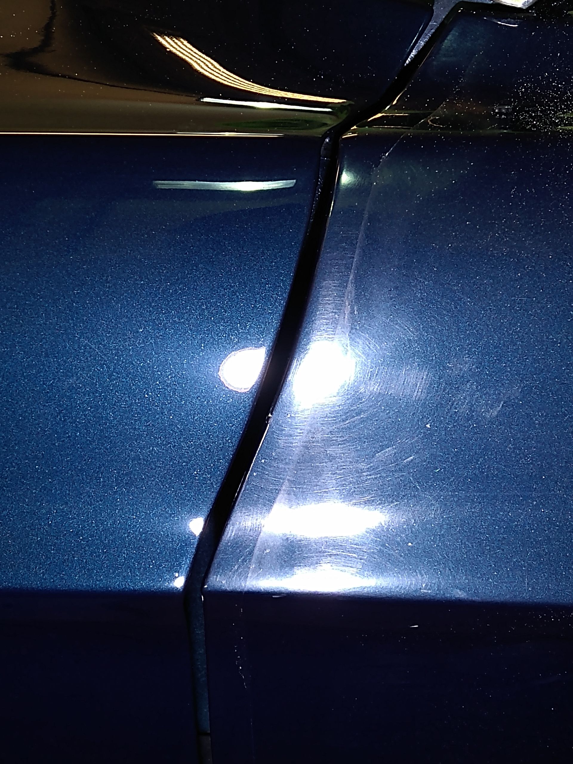 A close up of a blue car with a shiny finish