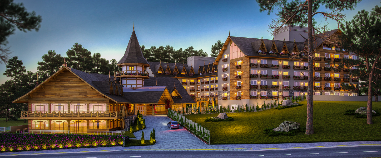 Um grande edifício com muitas janelas é cercado por árvores e grama.