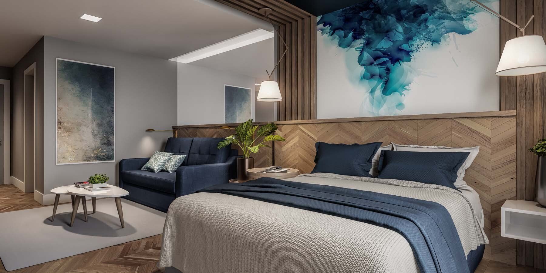 Conceito das acomodações do Aquan Prime Resort, com decorações de madeira e roupas de cama em tons de cinza e azul marinho.