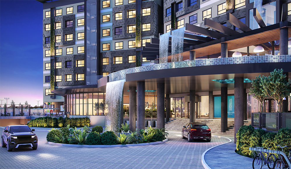 Um carro está estacionado em frente a um prédio com cachoeira.