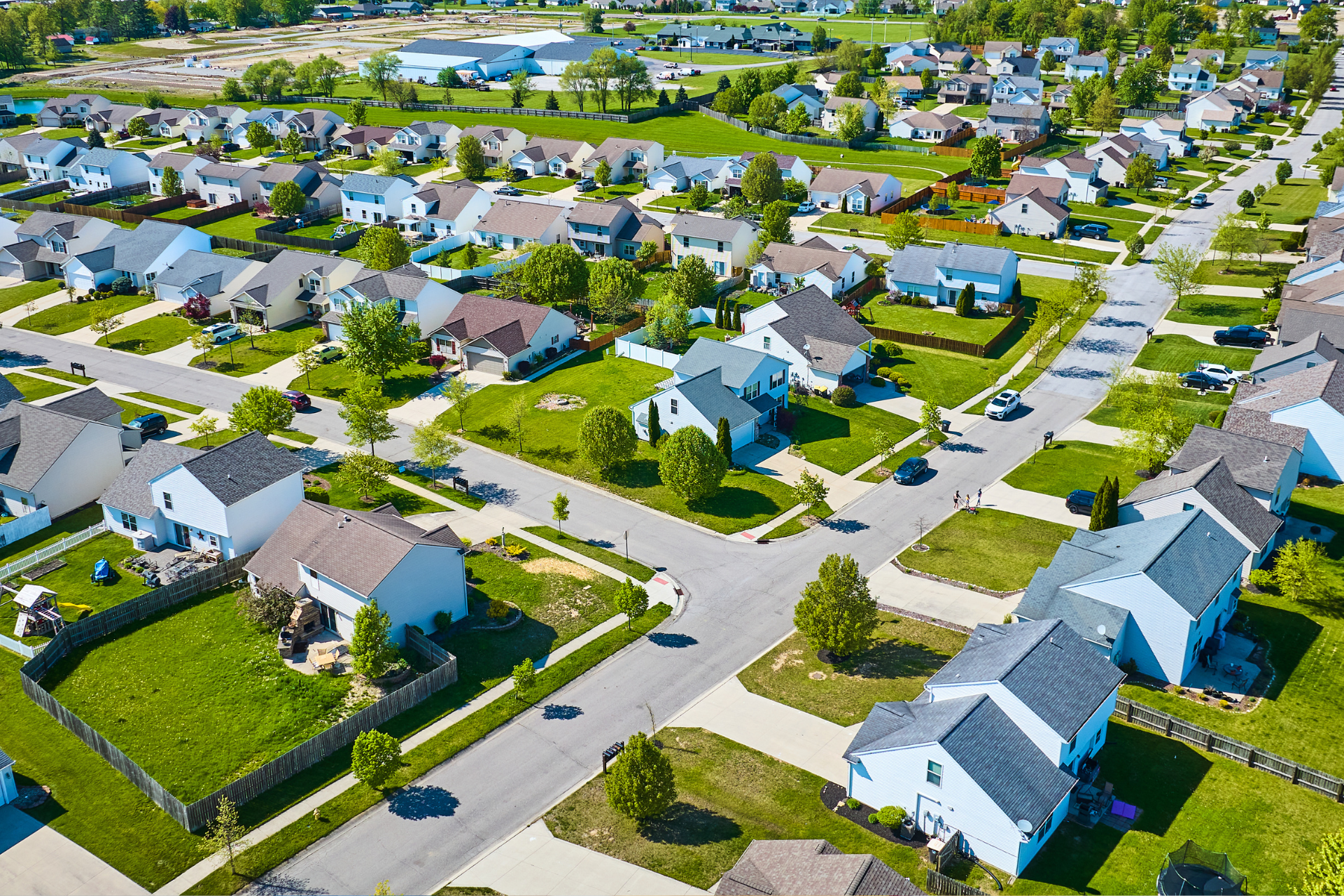 An aerial view of a residential neighborhood with lots of houses and trees.