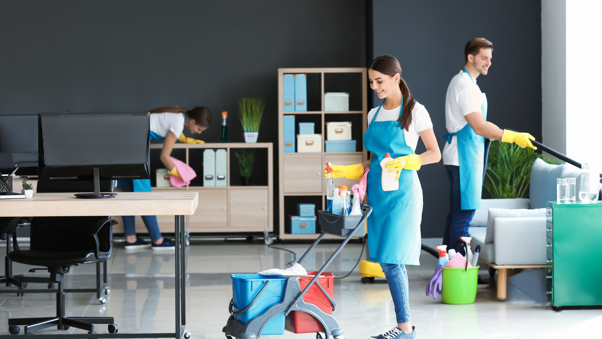 Person kneeling, measuring a wooden plank during floor installation, with tools nearby.