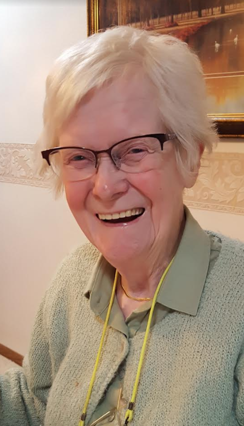 Senior woman smiling in a green shirt