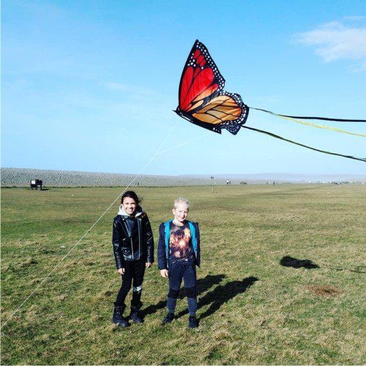 Flying a butterfly kite at Westward Ho! devon.