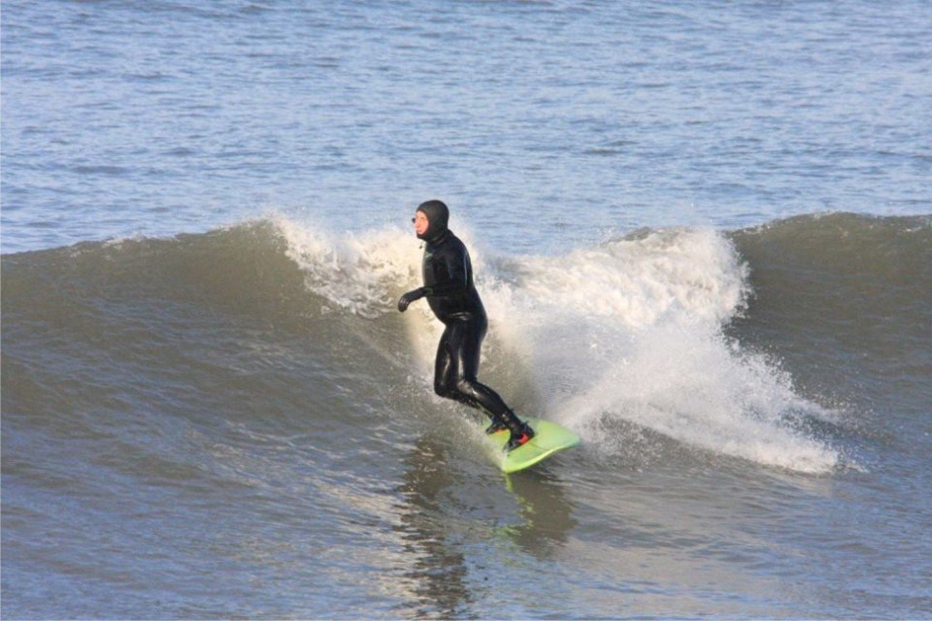 Surfer at Westward Ho! making the most of a small but perfect winter swell