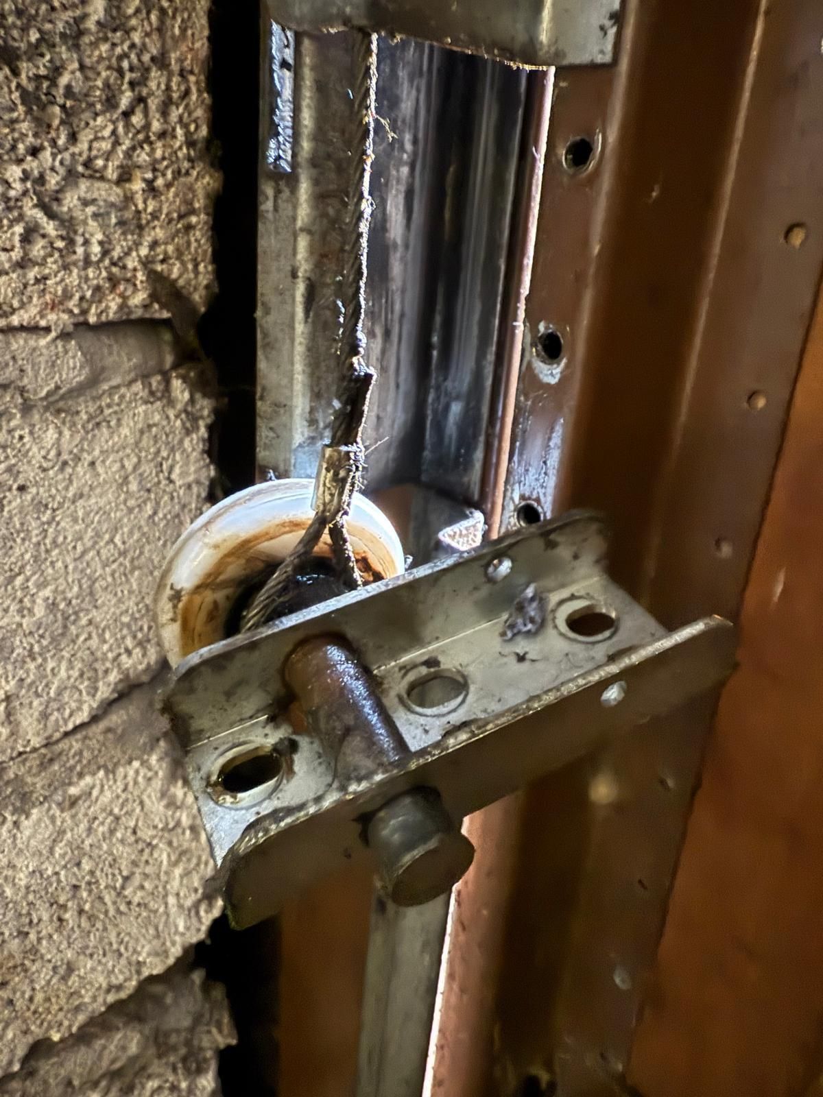 Replacing the side rollers on a garage door to make the door run freely and allow the electric operator to work well.