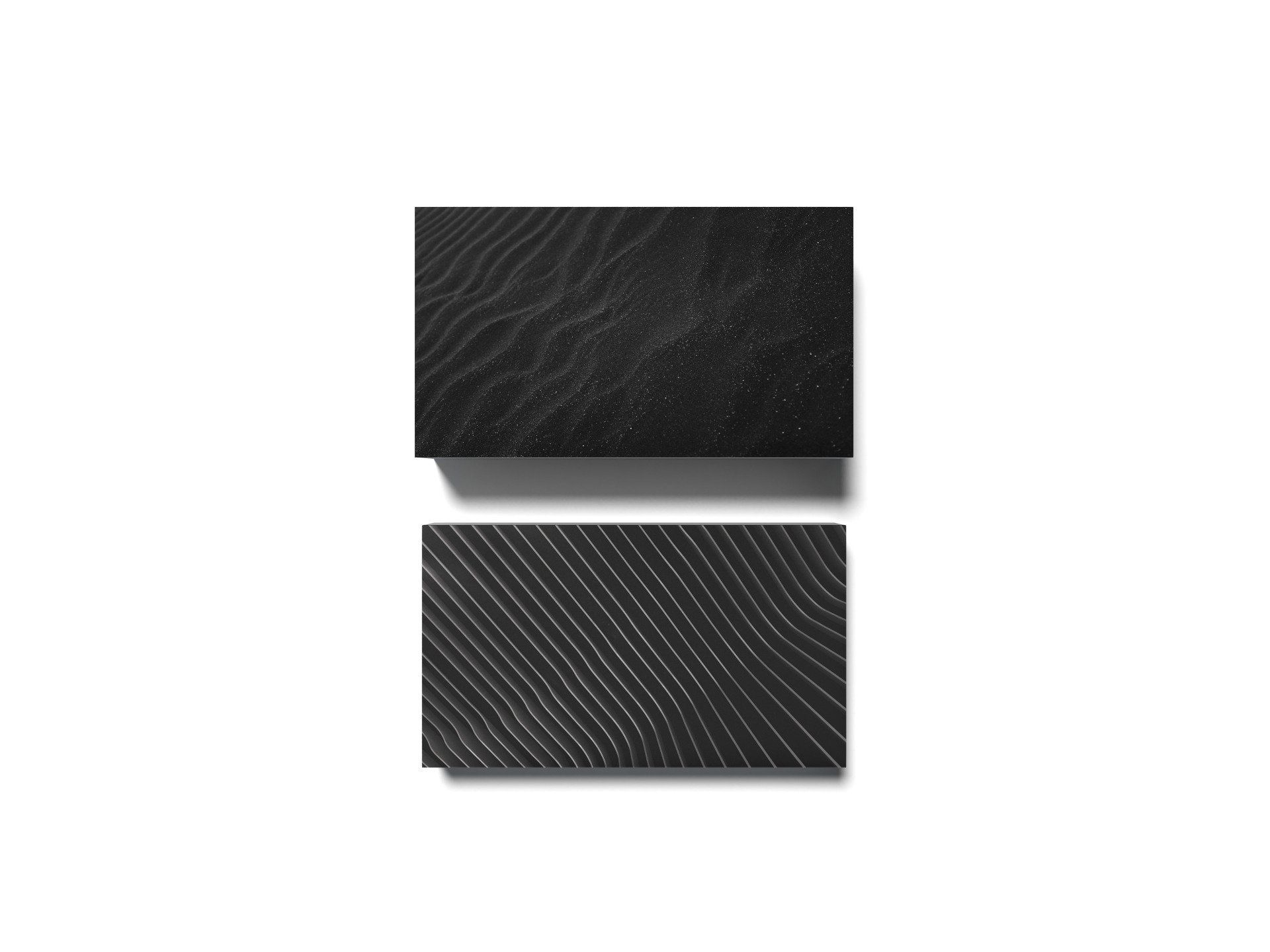 Two dark textured business cards, one with visible grain, the other with wavy line pattern.