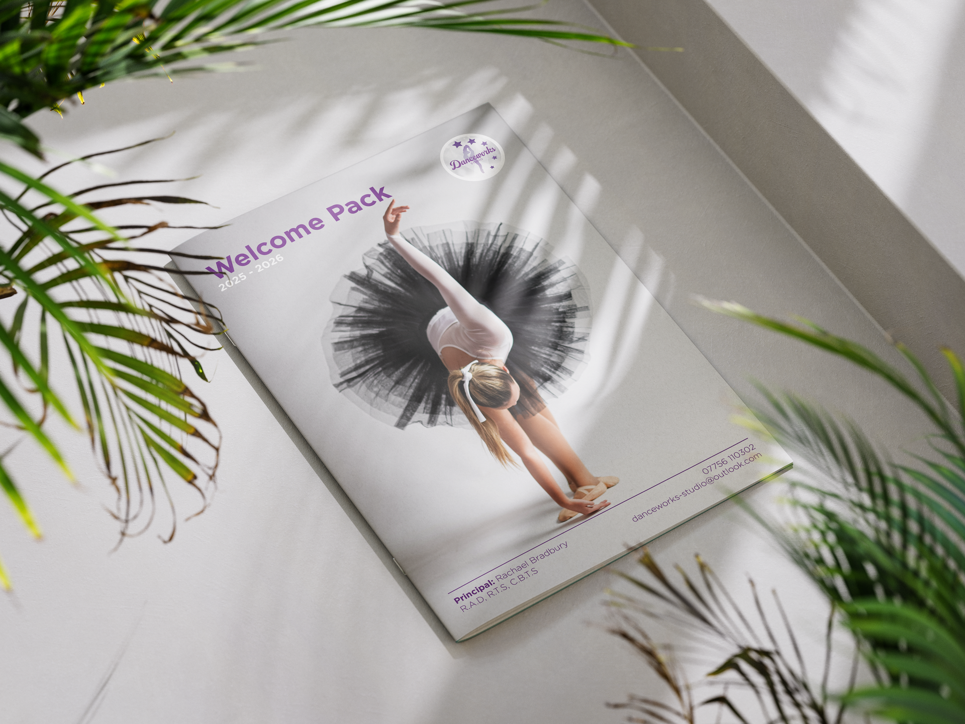 Welcome pack with ballerina illustration, resting on a white surface, with green plants.