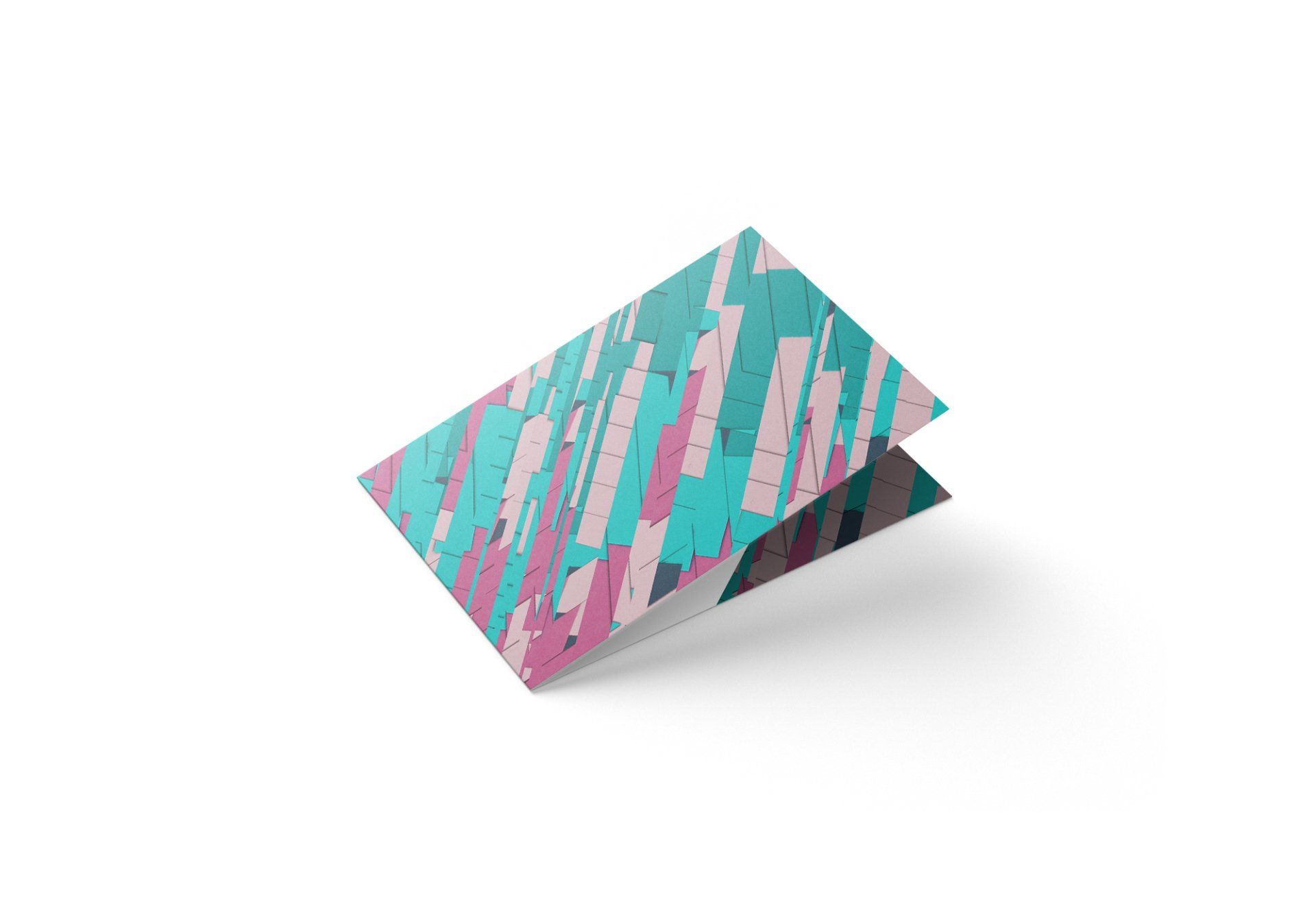 Folded card with abstract design of teal, pink, and gray rectangular shapes.