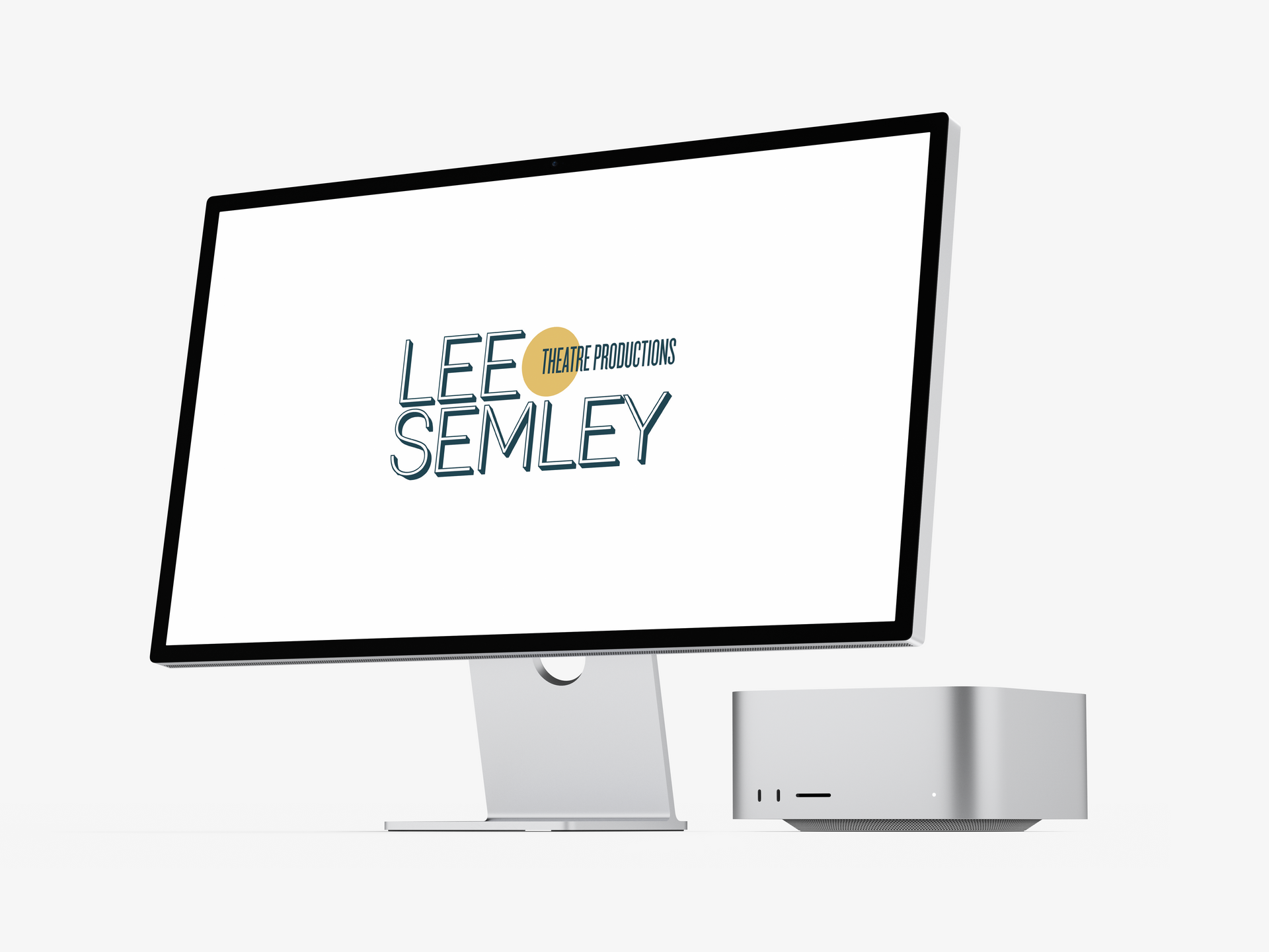 A silver computer monitor and desktop, displaying a logo reading 