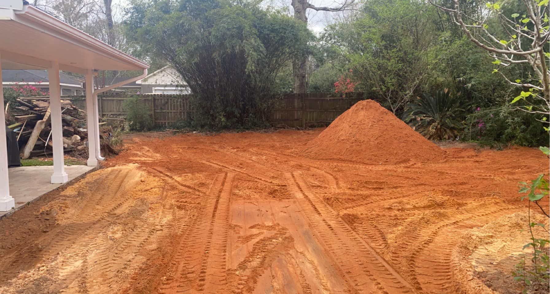 A pile of dirt is sitting in front of a house.