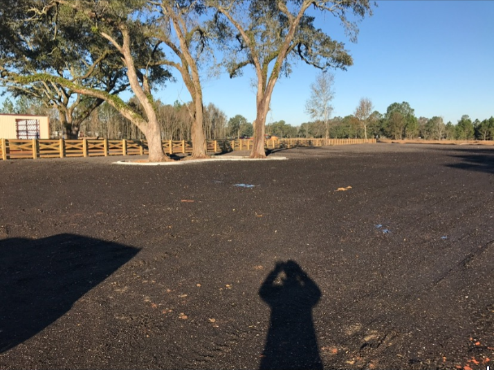 A shadow of a person standing in a parking lot