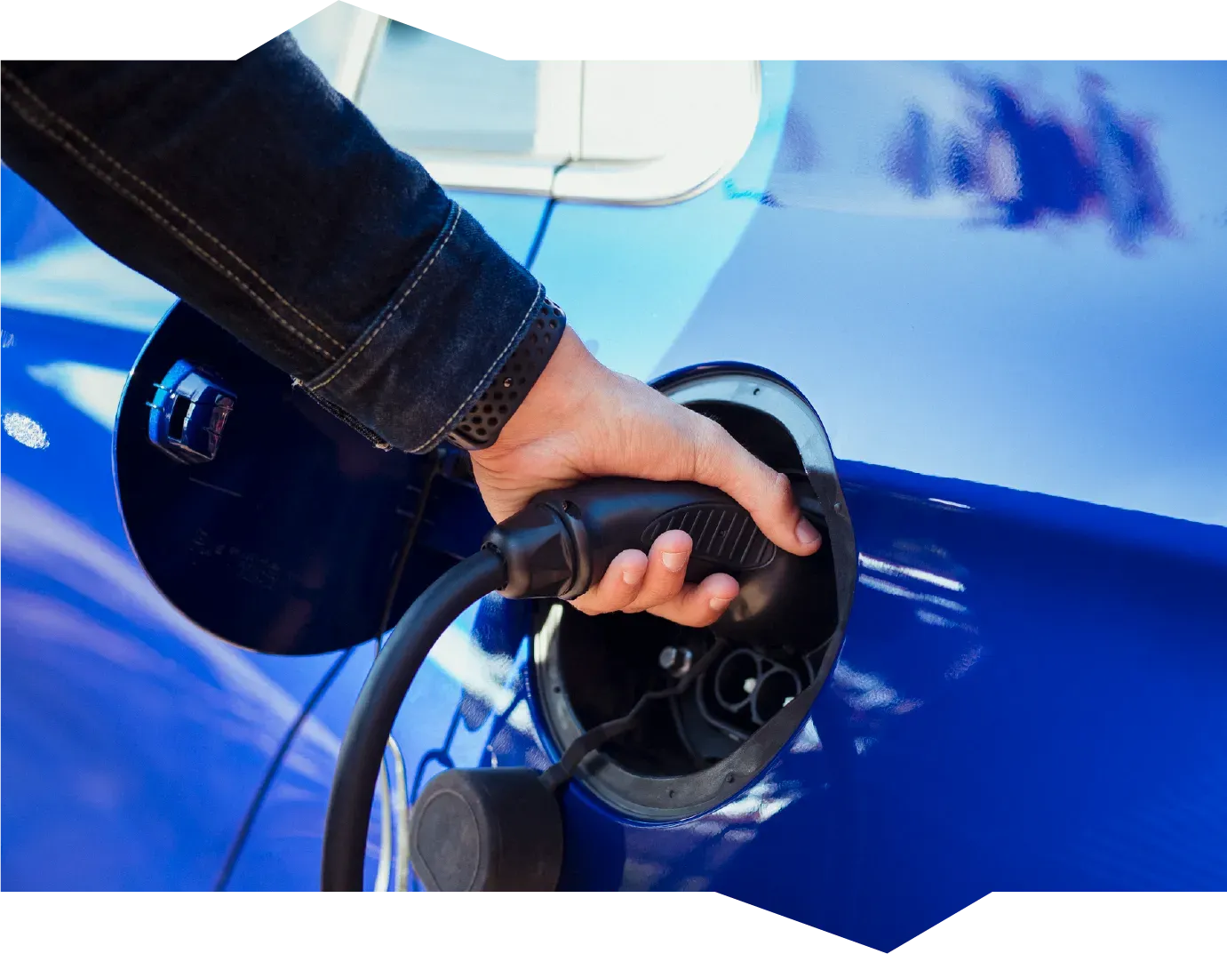 A person is opening a car door with a key.