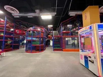 Tree Removal Service West Covina -Indoor children's play structure with colorful tubes, slides, and a claw machine.