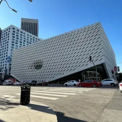 Tree Services West Covina – The Broad Museum in downtown Los Angeles features a unique honeycomb-like facade and is viewed from a street corner with a crosswalk and traffic.