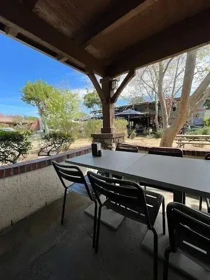 Tree Services West Covina – The outdoor seating area of Warehouse Pizza in West Covina is surrounded by beautiful trees that provide shade and enhance the ambiance.