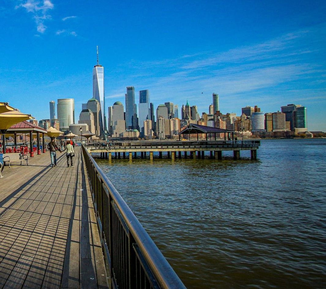 A view of the city skyline from a pier overlooking the water.