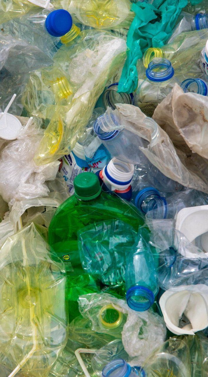 A pile of plastic bottles and bags sitting on top of each other.