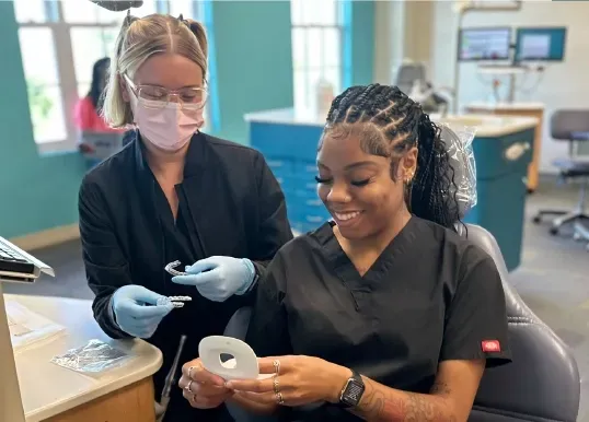 Patient smiling during Invisalign consultation reflecting Maple Orthodontics philosophy of comfortable, personalized orthodontic care