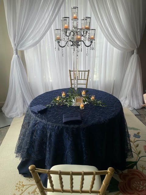 A table with a blue tablecloth and candles on it